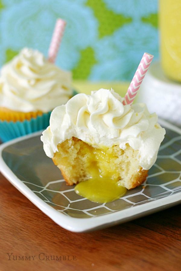 pineapple dole whip cupcakes filled with fresh Pineapple curd and topped with pineapple buttercream frosting