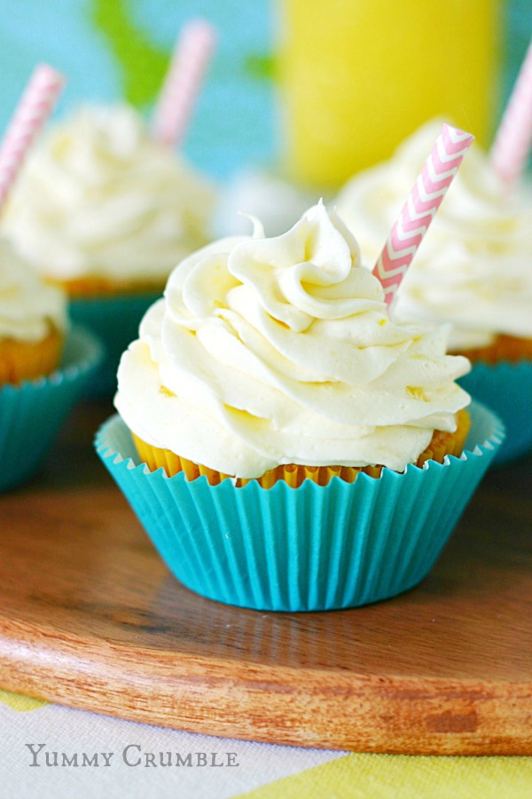 pineapple dole whip cupcakes filled with fresh Pineapple curd and topped with pineapple buttercream frosting