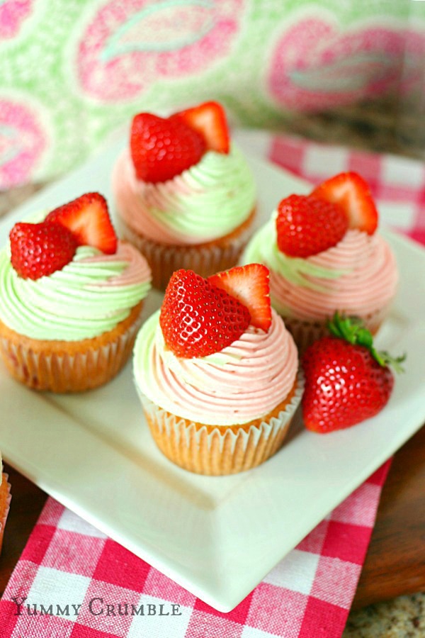 strawberry key lime cupcakes filled with key lime pie filling and topped with strawberry and lime buttercream fro