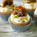 Baklava honey cupcakes with mascarpone whipped frosting and topped with a slice of baklava, pistachios, and honey drizzle - www.yummycrumble.com